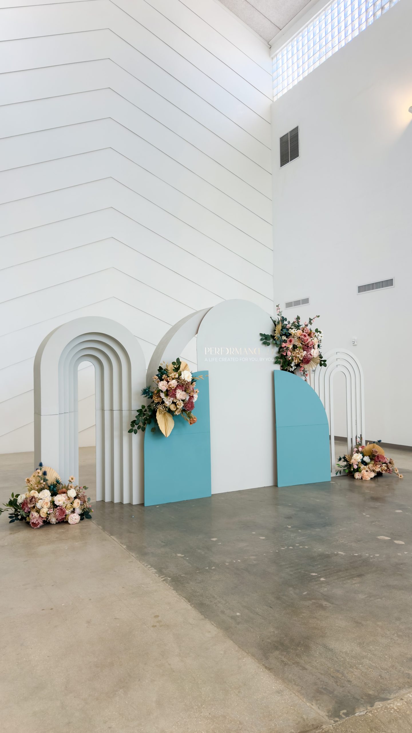 a white and blue stage with flowers